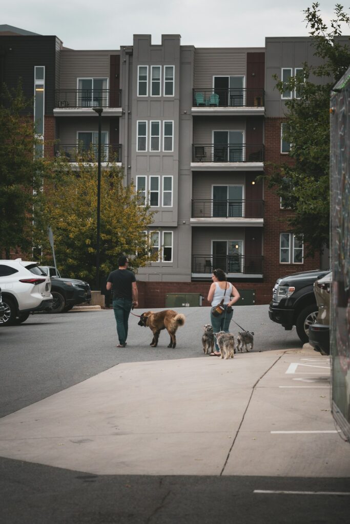 Neighbors walking their dogs outside an apartment building