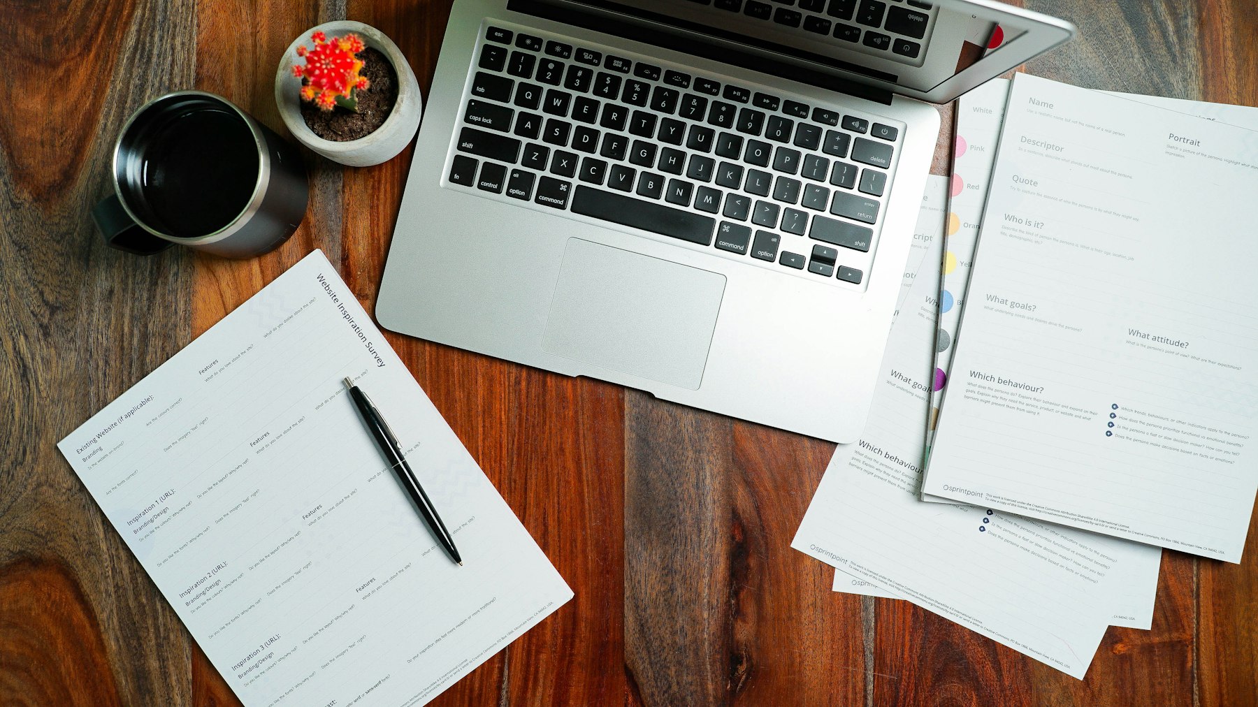 Paperwork and a laptop on a wooden desk