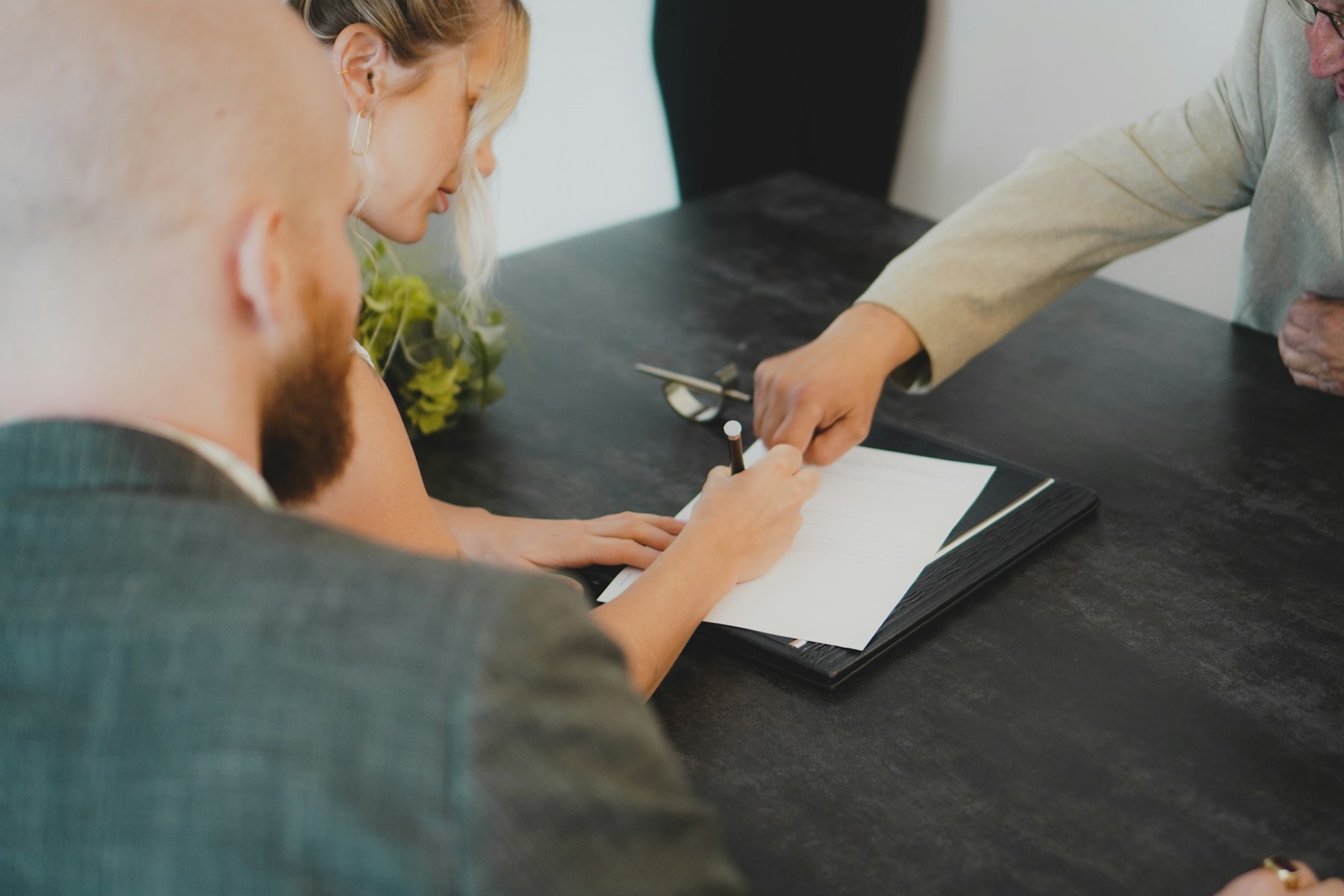 Couple signing a document at a desk